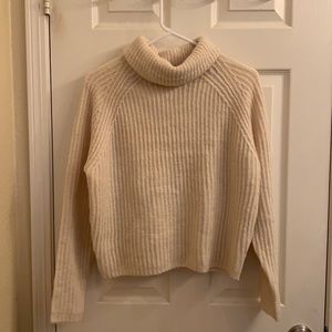 an xs garage cream turtleneck sweater